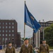 Service members representing Estonia carry the CIOR flag