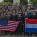 Service members from team USA and team Netherlands gather for a group photo