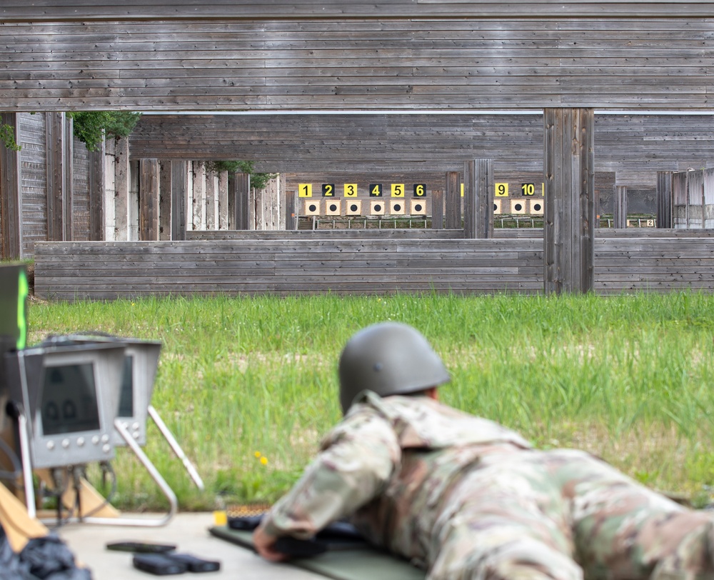 Sgt. 1st Class Benjamin Latham aims down the sights of a LMT R-20 Rahe rifle