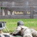 Sgt. 1st Class Benjamin Latham aims down the sights of a LMT R-20 Rahe rifle