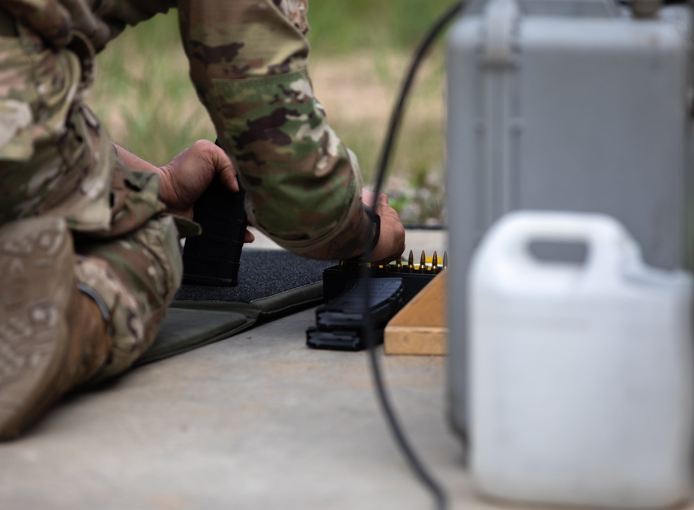 Lt. Col. Thomas Sebastiani loads a LMT R-20 Rahe rifle magazine