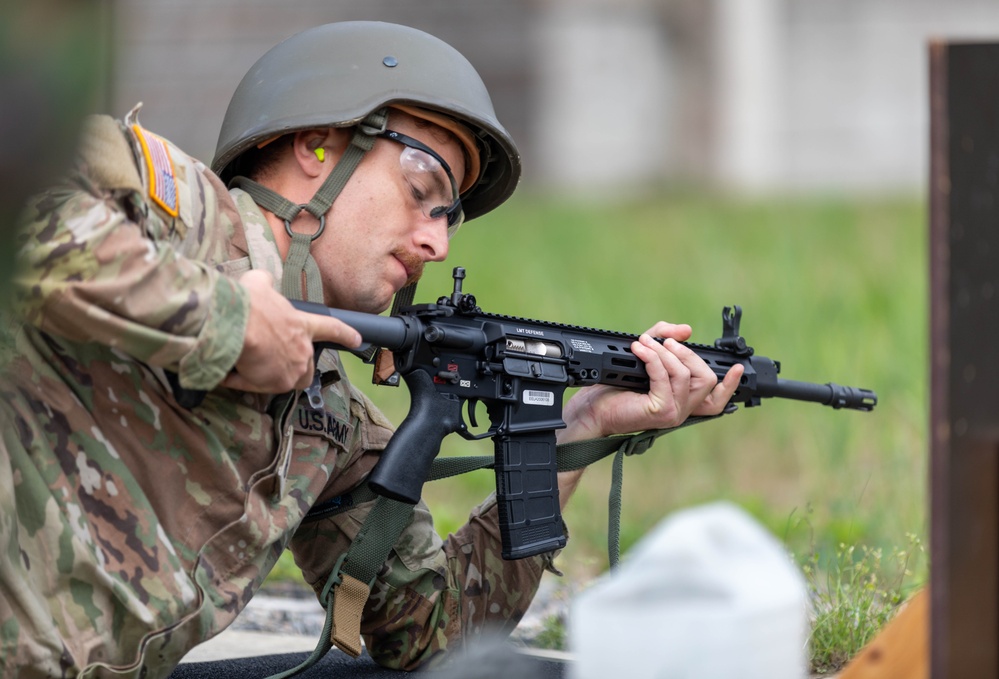 Staff Sgt. Conner Williams adjusts the buttstock of a LMT R20 RAHE rifle