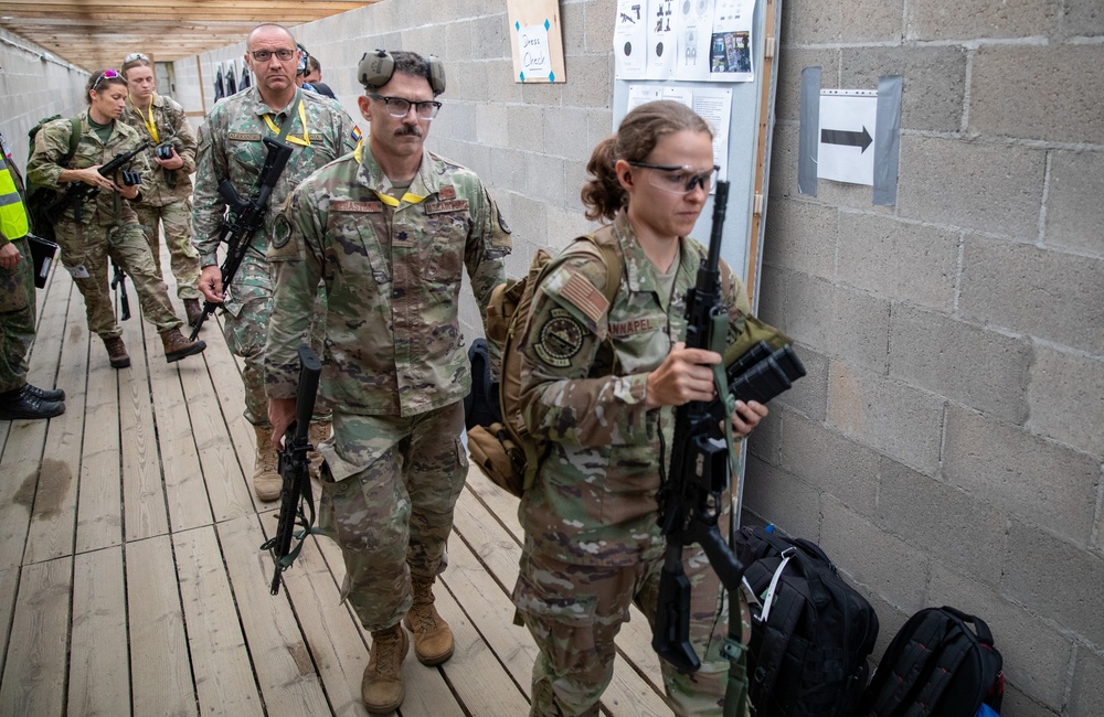 Competitors enter a rifle range