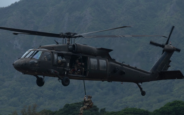 Explosive Ordnance Disposal technician rappels from U.S. Army UH-60 Black Hawk during RIMPAC 2024