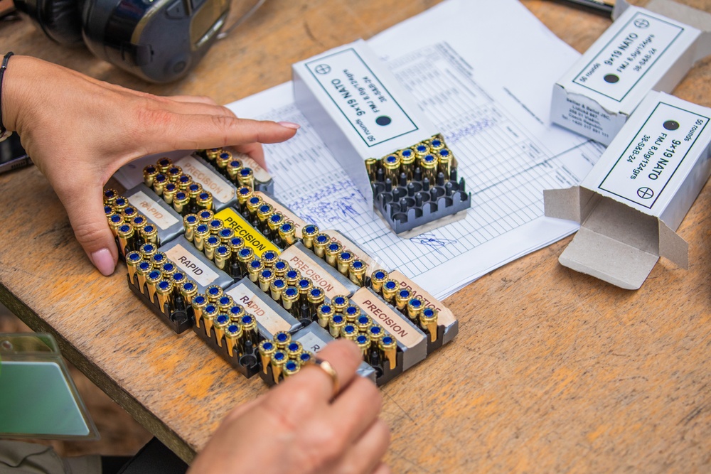 An Estonian volunteer readies ammunition for team USA