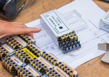 An Estonian volunteer readies ammunition for team USA
