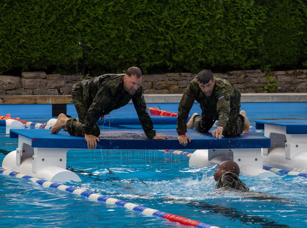 Maj. Sterling Broadhead helps fellow teammate during a competition