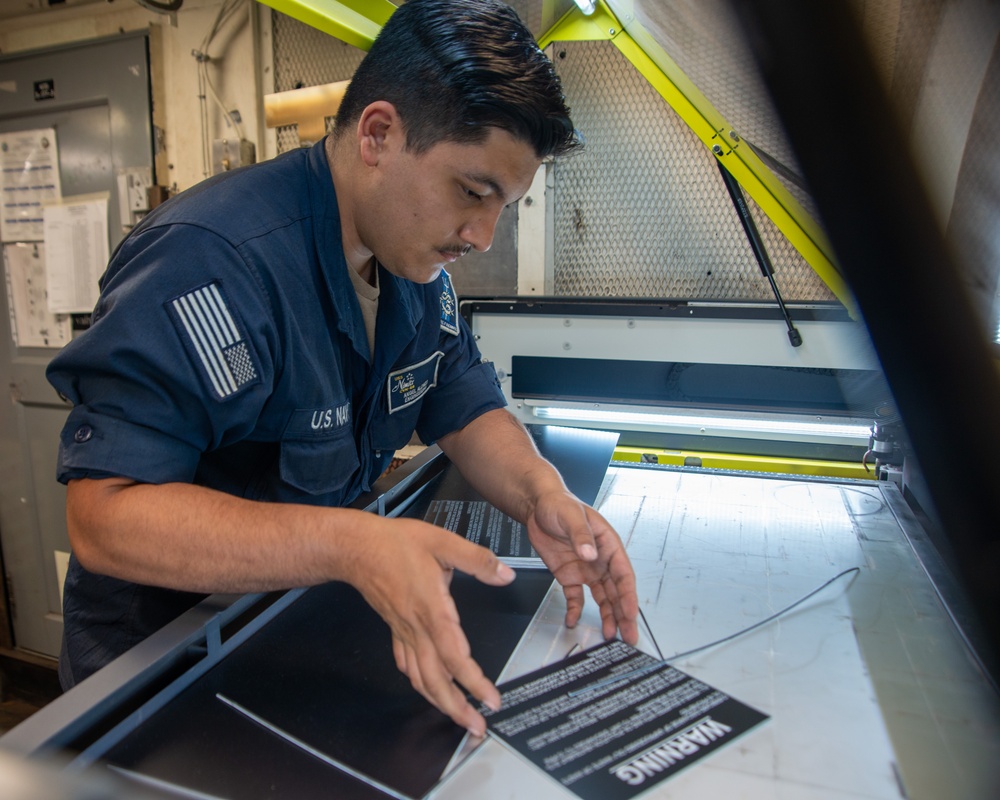 Nimitz Sailor Inspects Plaques
