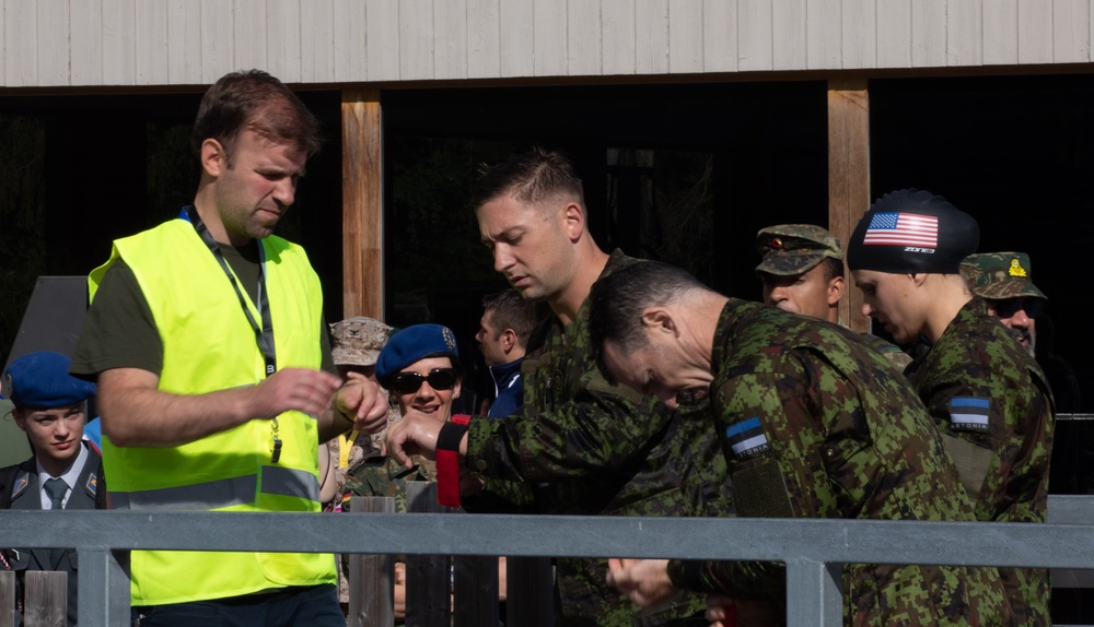 Service members prepare to conduct a swim obstacle course