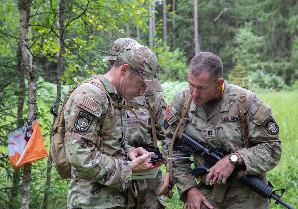 Service members  navigate during a orienteering competition