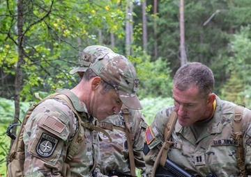 Service members  navigate during a orienteering competition