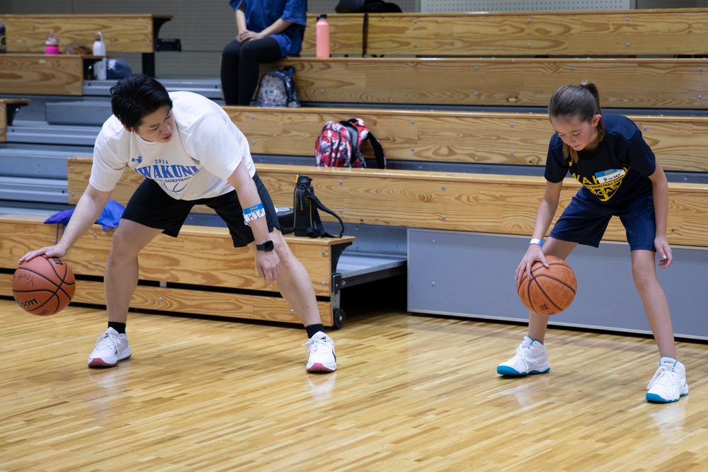 Coaches from Basketball Japan Academy coach children at the Youth Sports Summer Basketball Camp