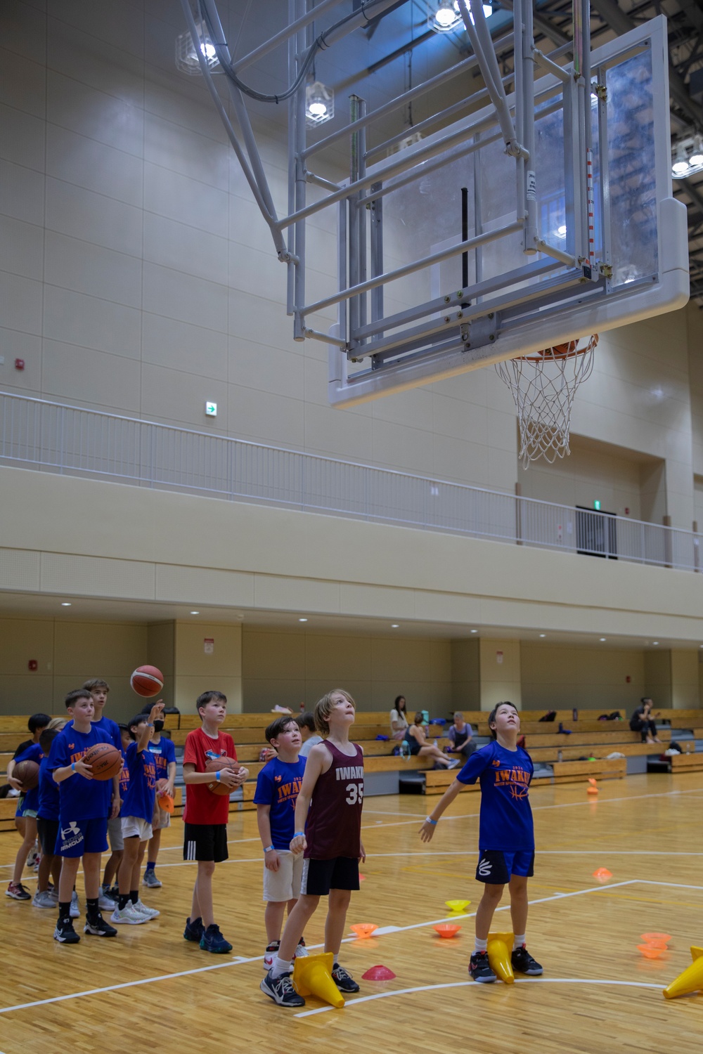 Coaches from Basketball Japan Academy coach children at the Youth Sports Summer Basketball Camp