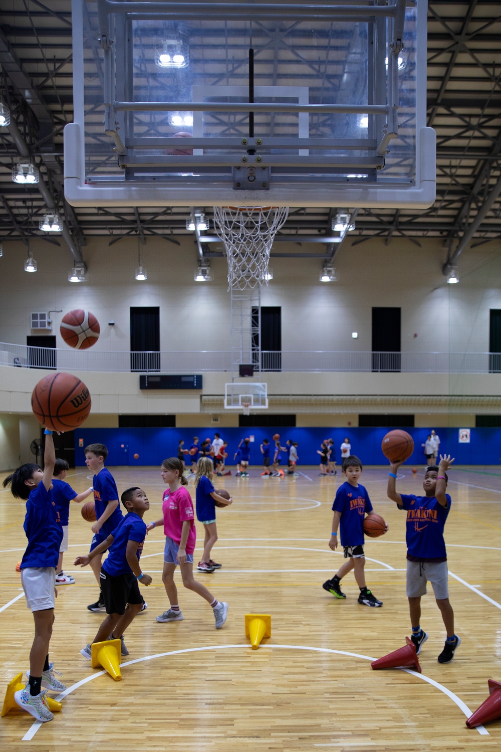 Coaches from Basketball Japan Academy coach children at the Youth Sports Summer Basketball Camp