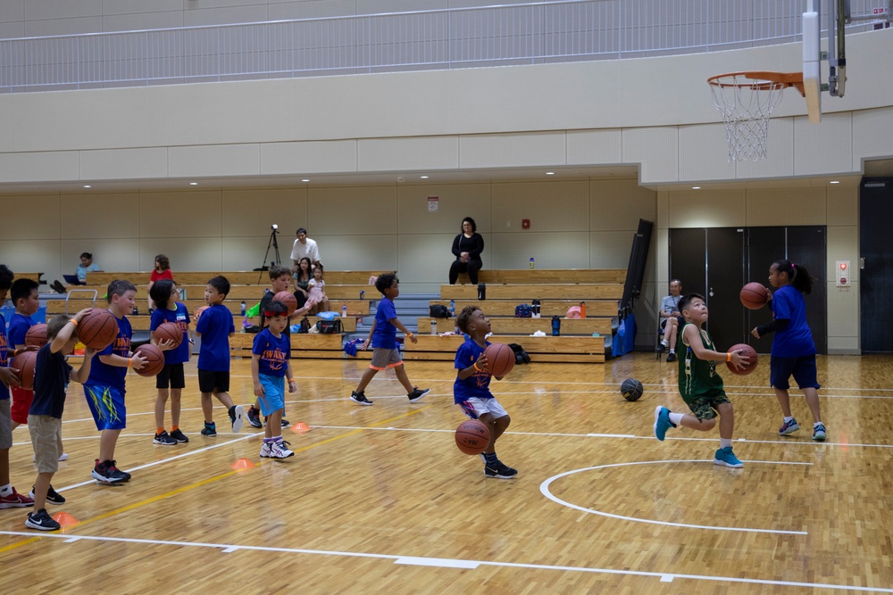 Coaches from Basketball Japan Academy coach children at the Youth Sports Summer Basketball Camp