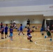 Coaches from Basketball Japan Academy coach children at the Youth Sports Summer Basketball Camp