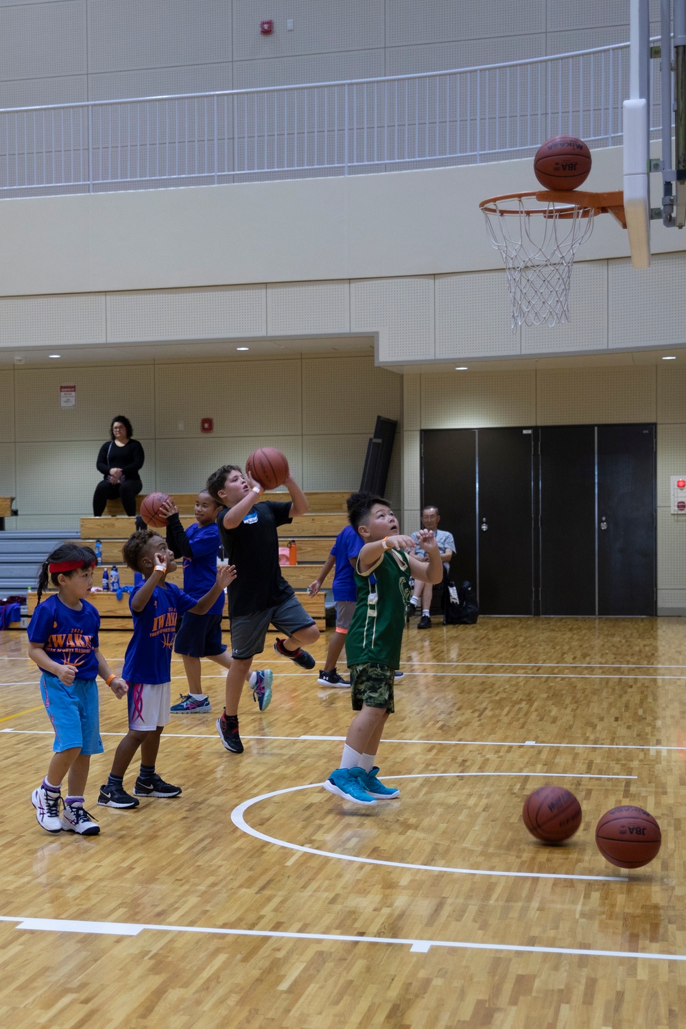 Coaches from Basketball Japan Academy coach children at the Youth Sports Summer Basketball Camp