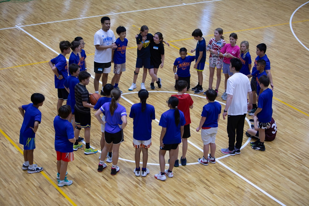 Coaches from Basketball Japan Academy coach children at the Youth Sports Summer Basketball Camp