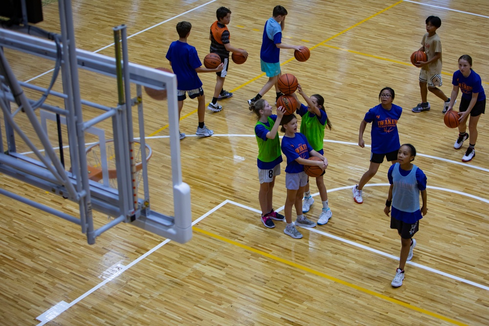 Coaches from Basketball Japan Academy coach children at the Youth Sports Summer Basketball Camp