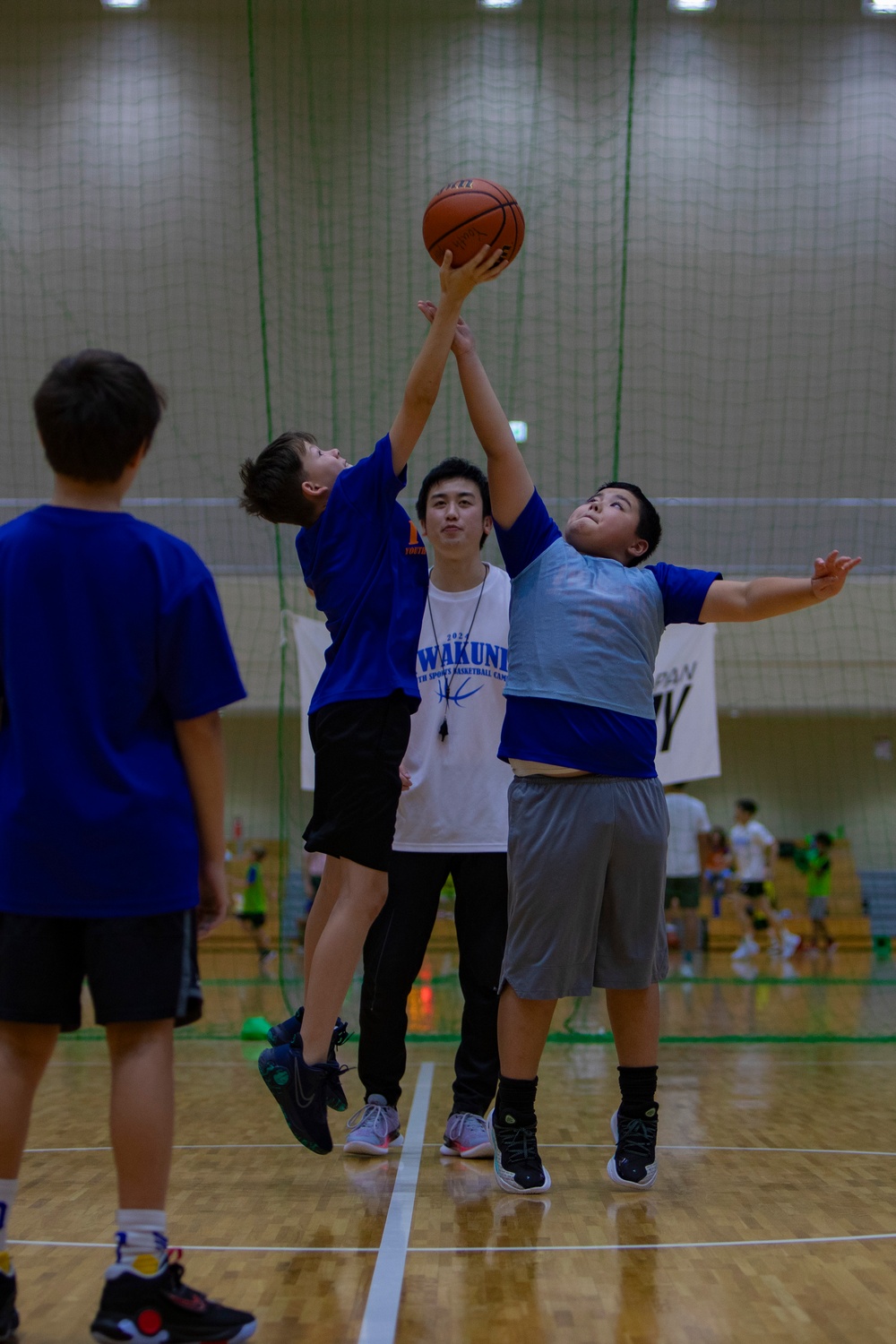 Coaches from Basketball Japan Academy coach children at the Youth Sports Summer Basketball Camp