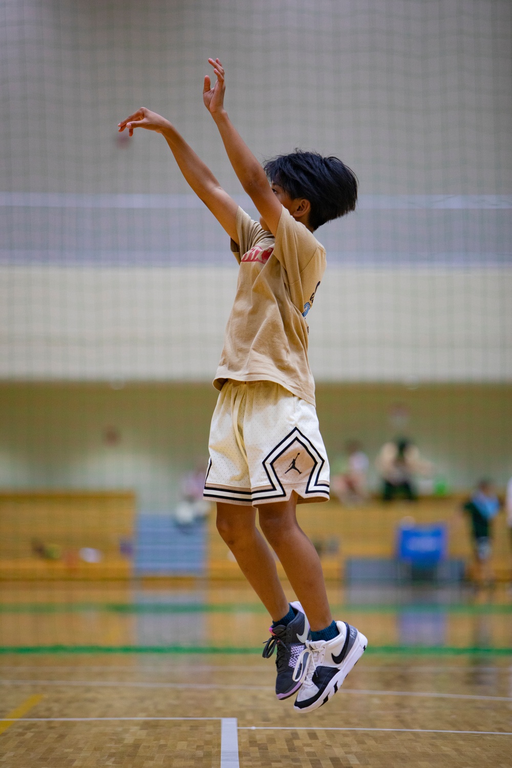 Coaches from Basketball Japan Academy coach children at the Youth Sports Summer Basketball Camp