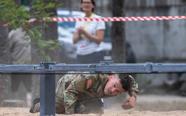 Sgt. Trenton Tuberosa crawls through an obstacle