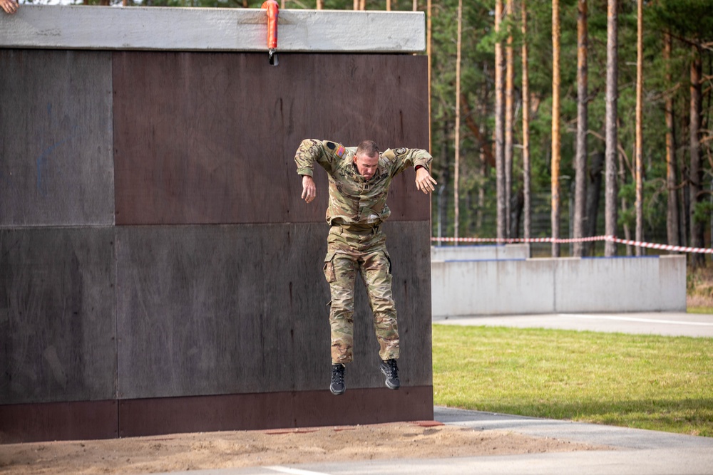 Capt. Zachary Grimes jumps off an obstacle