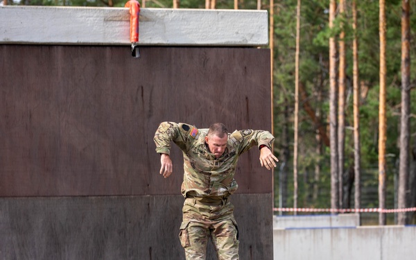 Capt. Zachary Grimes jumps off an obstacle