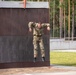 Capt. Zachary Grimes jumps off an obstacle