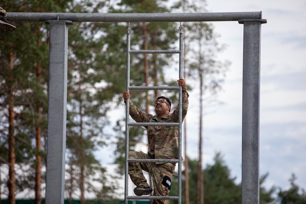 Sgt. 1st Class David Duran climbs up a ladder
