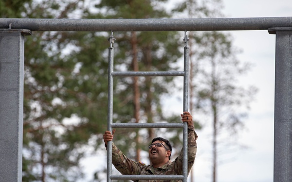 Sgt. 1st Class David Duran climbs up a ladder