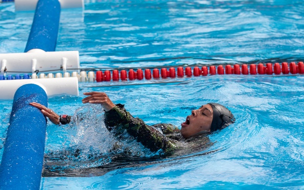 1st Lt. Jessica Romero pushes off an obstacle