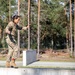 1st Lt. Jessica Romero walks over a concrete obstacle