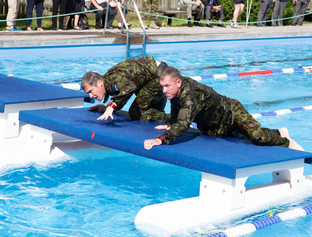 Col. Brent Dishman and Capt. Zachary Grimes climb on the table top
