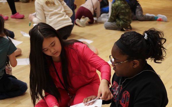 Children problem solve during WRAIR’s egg drop competition