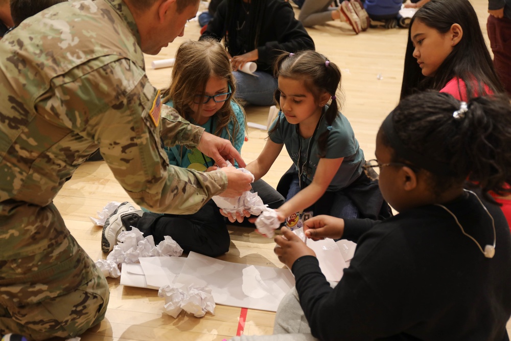 Children problem solve during WRAIR’s egg drop competition