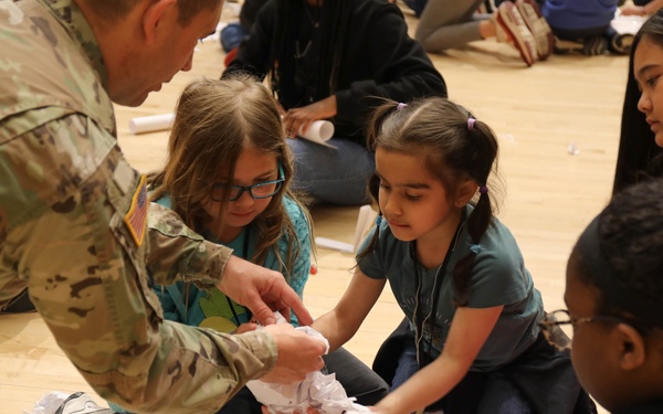 Children problem solve during WRAIR’s egg drop competition