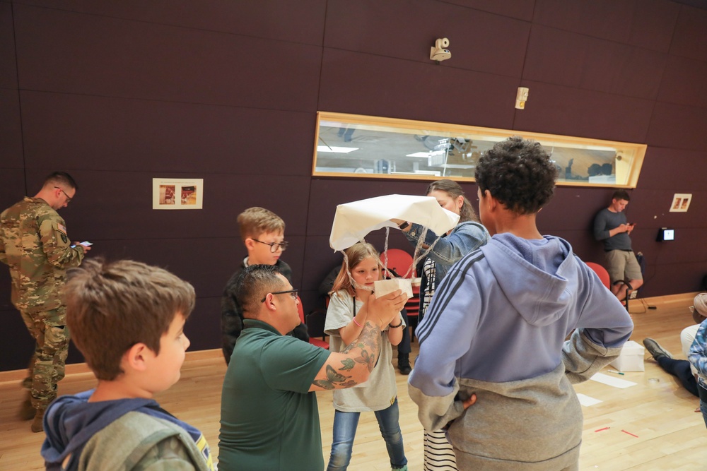 Children problem solve during WRAIR’s egg drop competition