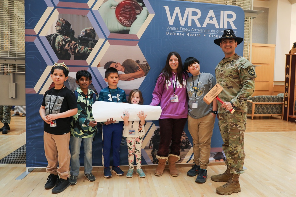 Children problem solve during WRAIR’s egg drop competition