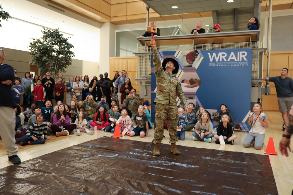 Children problem solve during WRAIR’s egg drop competition