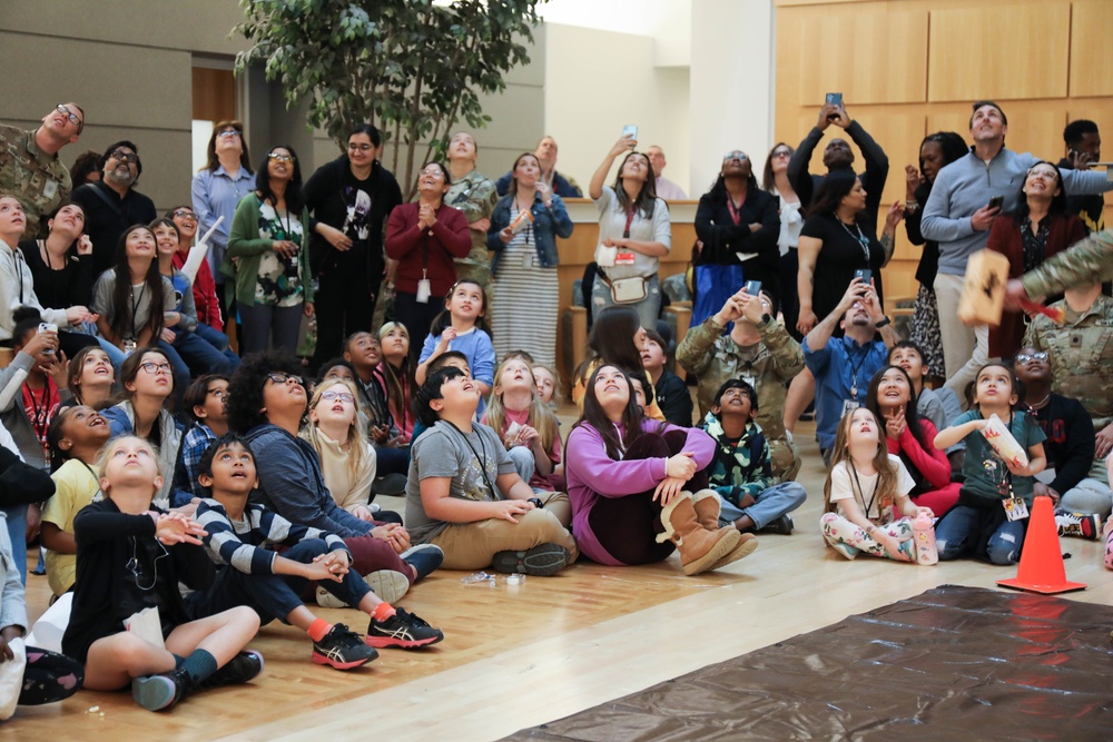 Children problem solve during WRAIR’s egg drop competition