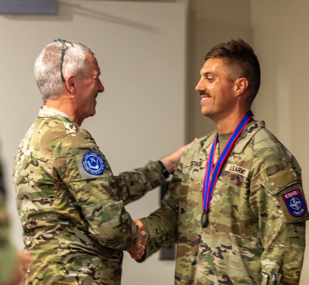 Capt. Jack Straub recieves a medal and handshake