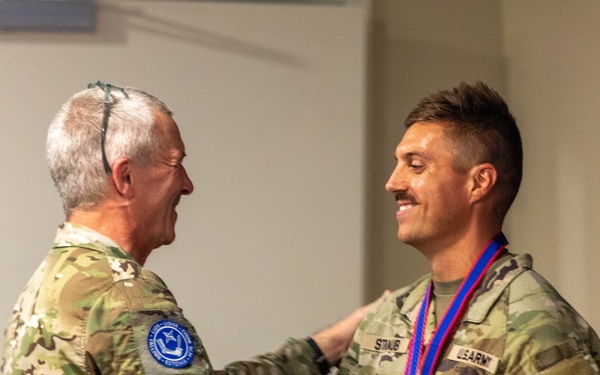 Capt. Jack Straub recieves a medal and handshake