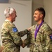Capt. Jack Straub recieves a medal and handshake