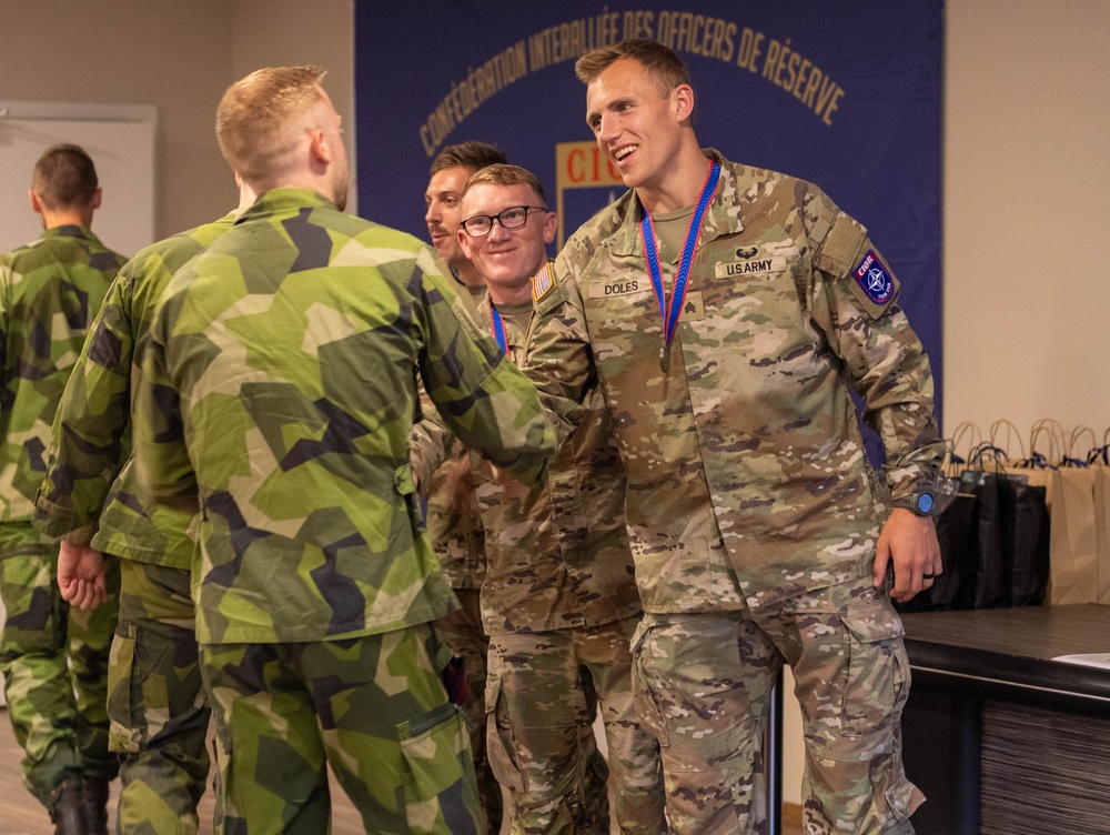 Sgt. Thomas Doles shakes hands with a  Swedish competitor