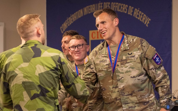 Sgt. Thomas Doles shakes hands with a  Swedish competitor