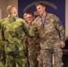 Sgt. Thomas Doles shakes hands with a  Swedish competitor