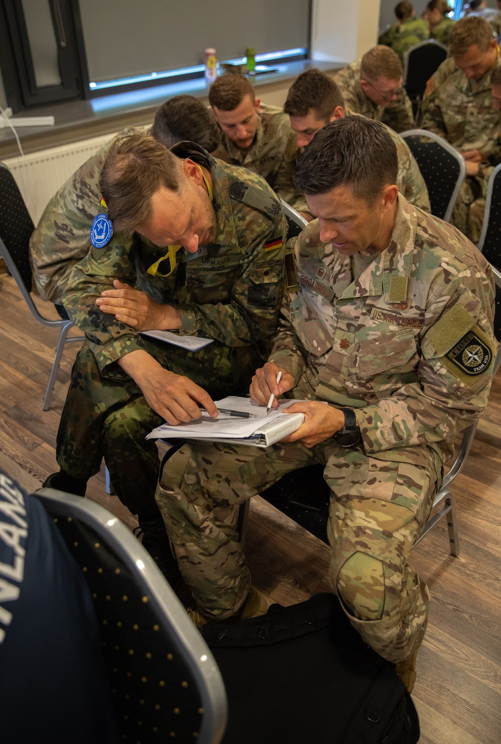 Maj. Sterling Broadhead works with teammate Maj. Daniel Uphaus