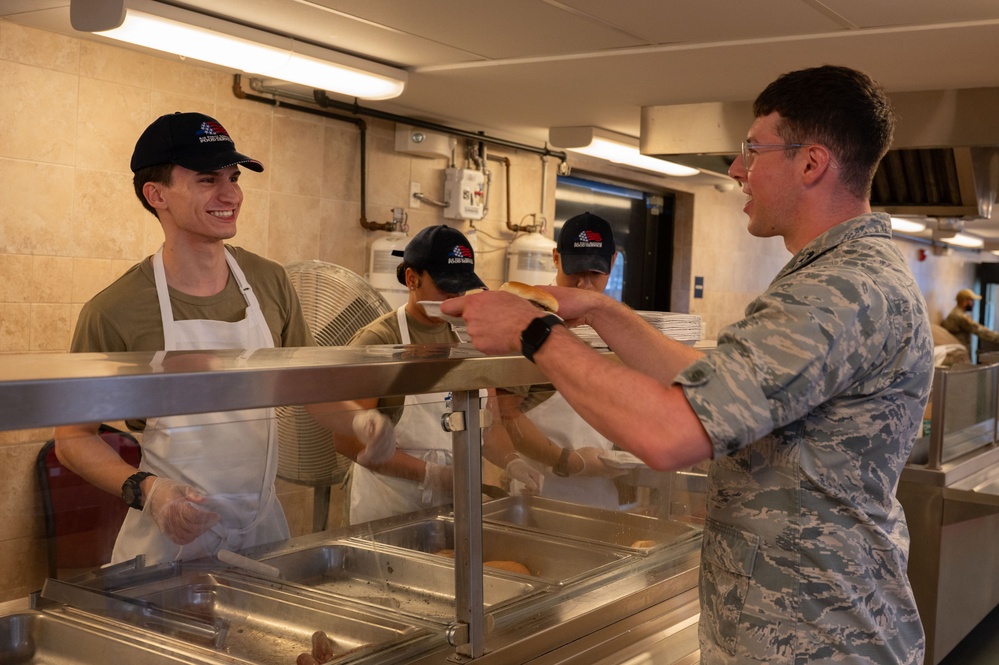 Services specialists prepare meals for Civil Air Patrol cadets