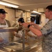 Services specialists prepare meals for Civil Air Patrol cadets